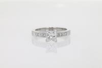 Channel Set Diamond Ring with Four Princess Cut Diamonds On Each Side